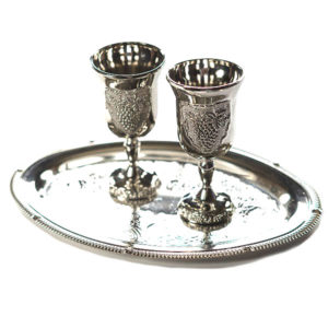 two silver communion cups on a tray