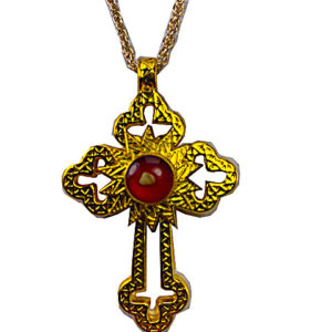 a cross with a red stone