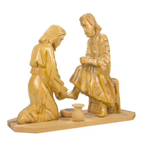 carved figures of Jesus washing feet