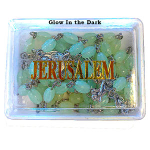A glow in the dark Rosary inside of its box